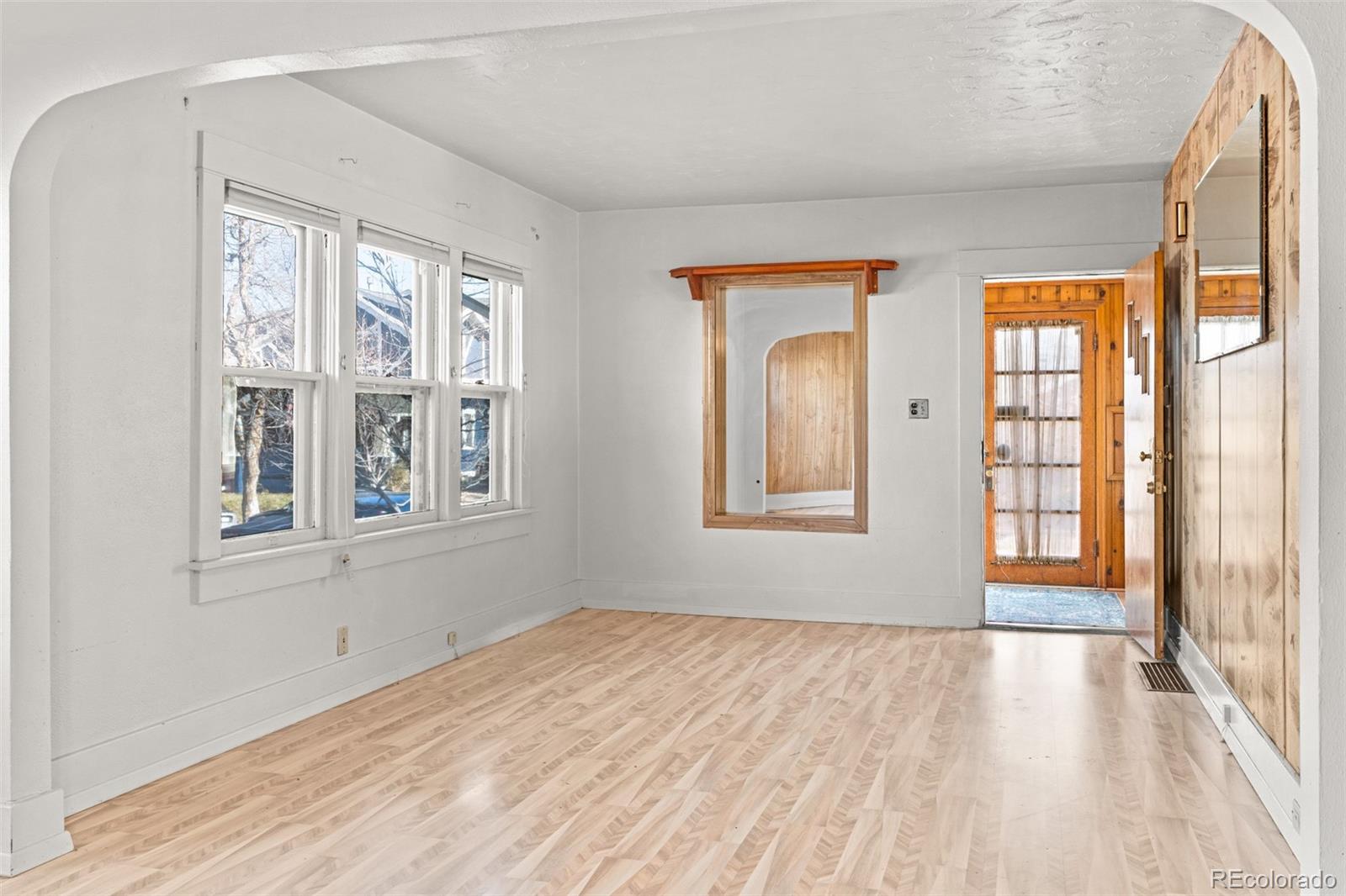 5919 South Bemis Street Littleton, CO 80120 - Photo 8 of 43 a view of an empty room with wooden floor and a window