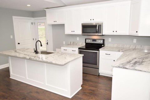 807 Clear Creek Road Pulaski, TN 38478 - Photo 4 of 19 a kitchen with granite countertop a stove and a sink