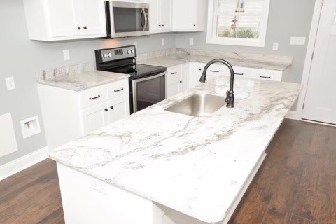 807 Clear Creek Road Pulaski, TN 38478 - Photo 5 of 19 a kitchen with granite countertop a sink a stove and a microwave