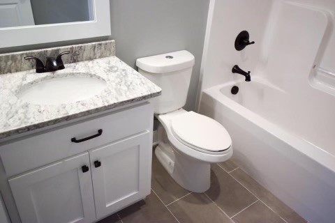 807 Clear Creek Road Pulaski, TN 38478 - Photo 8 of 19 a bathroom with a granite countertop sink a toilet a mirror and shower