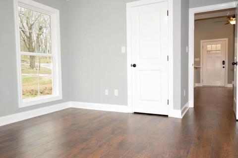 807 Clear Creek Road Pulaski, TN 38478 - Photo 9 of 19 an empty room with wooden floor and windows