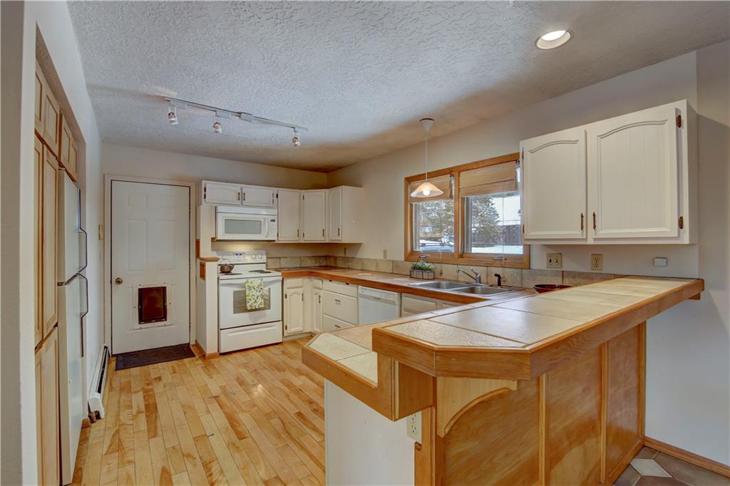 371 Alpine Road Dillon, CO 80435 - Photo 2 of 34 a kitchen with stainless steel appliances granite countertop a sink stove and refrigerator
