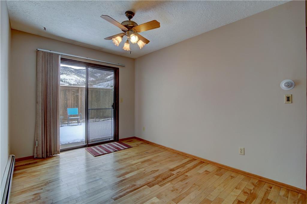 371 Alpine Road Dillon, CO 80435 - Photo 11 of 34 an empty room with wooden floor and windows