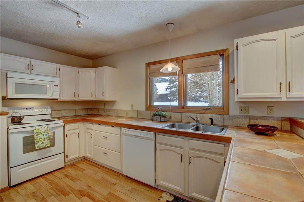 371 Alpine Road Dillon, CO 80435 - Photo 13 of 34 a kitchen with a sink stove and cabinets