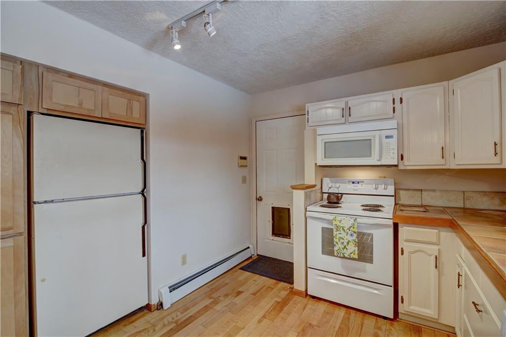371 Alpine Road Dillon, CO 80435 - Photo 14 of 34 a kitchen with stainless steel appliances a refrigerator stove and microwave
