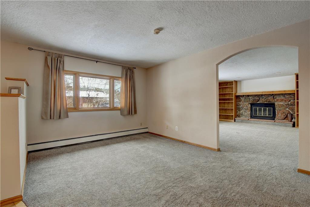 371 Alpine Road Dillon, CO 80435 - Photo 7 of 34 an empty room with fireplace and a window
