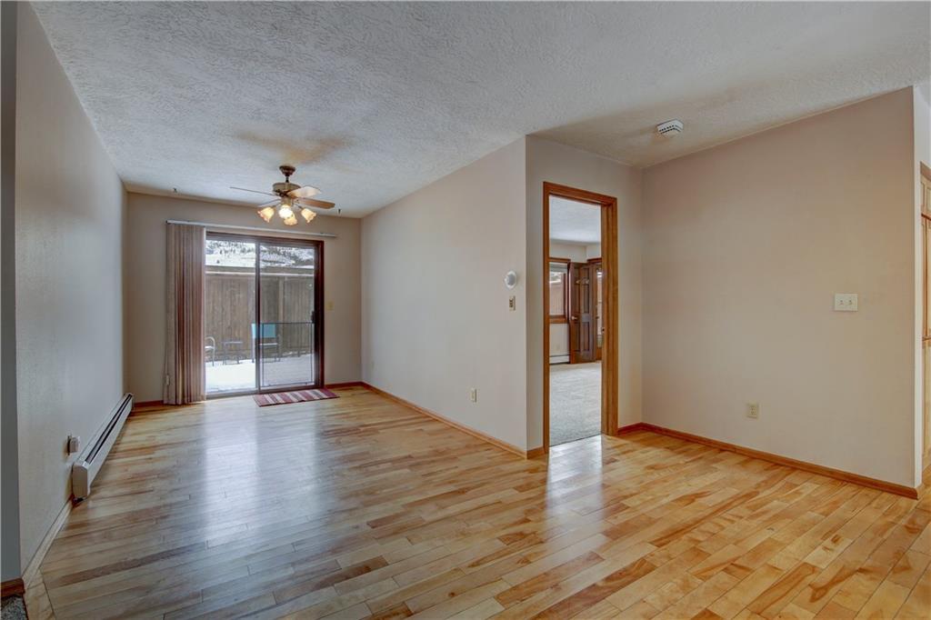 371 Alpine Road Dillon, CO 80435 - Photo 10 of 34 an empty room with wooden floor and chandelier