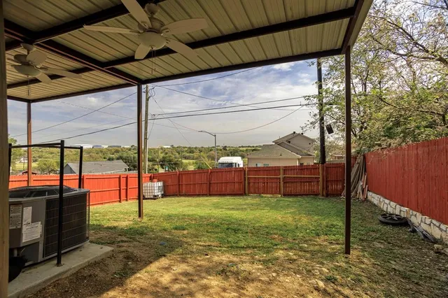 a view of yard with tree and deck