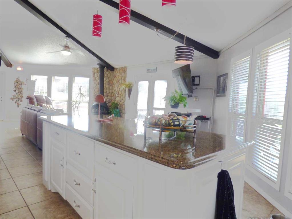 149 Bay Roc Lane Runaway Bay, TX 76426 - Photo 11 of 35 a kitchen with stainless steel appliances granite countertop a sink window and cabinets