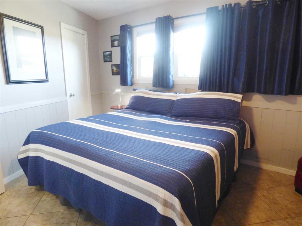 149 Bay Roc Lane Runaway Bay, TX 76426 - Photo 12 of 35 a bedroom with a bed and a mirror