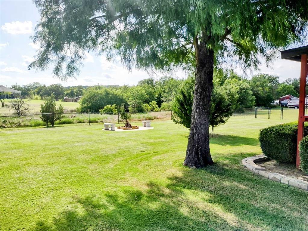 149 Bay Roc Lane Runaway Bay, TX 76426 - Photo 26 of 35 a view of a swimming pool and a garden