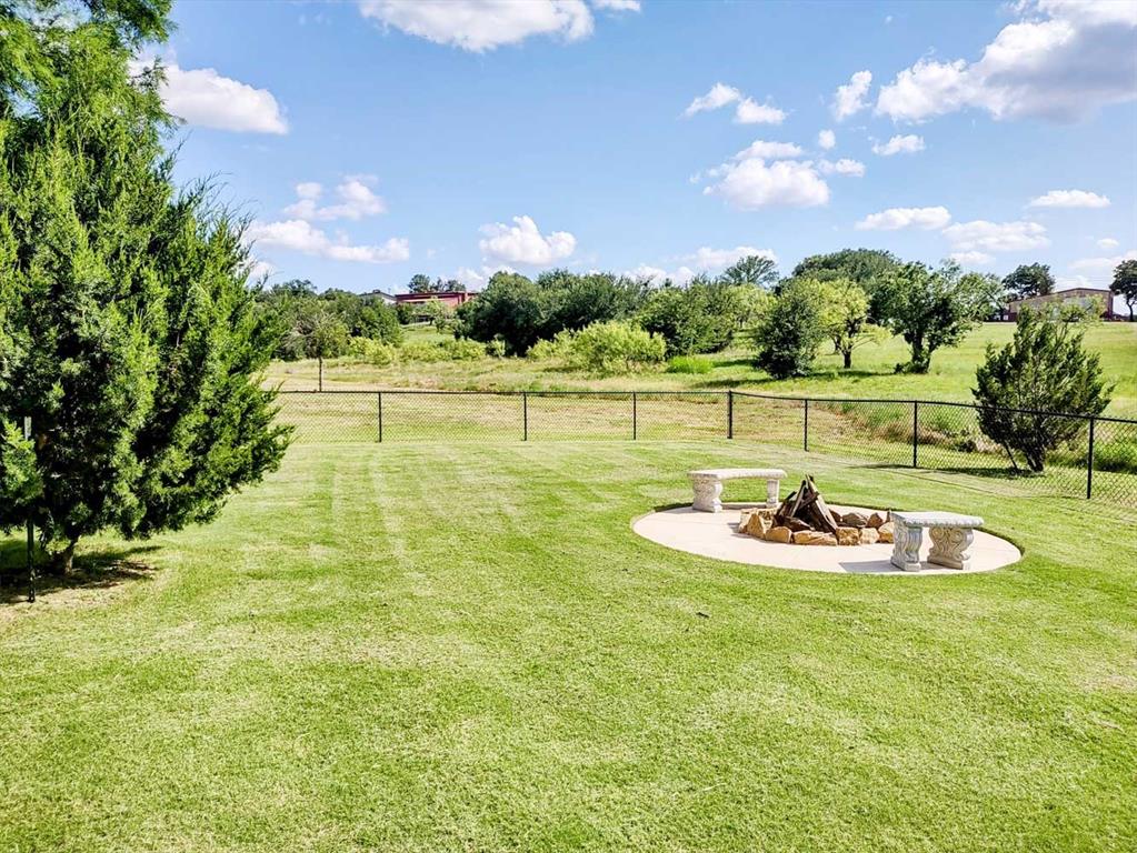 149 Bay Roc Lane Runaway Bay, TX 76426 - Photo 28 of 35 a view of a swimming pool and a yard