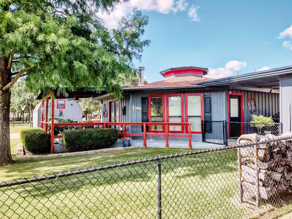 149 Bay Roc Lane Runaway Bay, TX 76426 - Photo 30 of 35 a front view of house with yard and outdoor seating