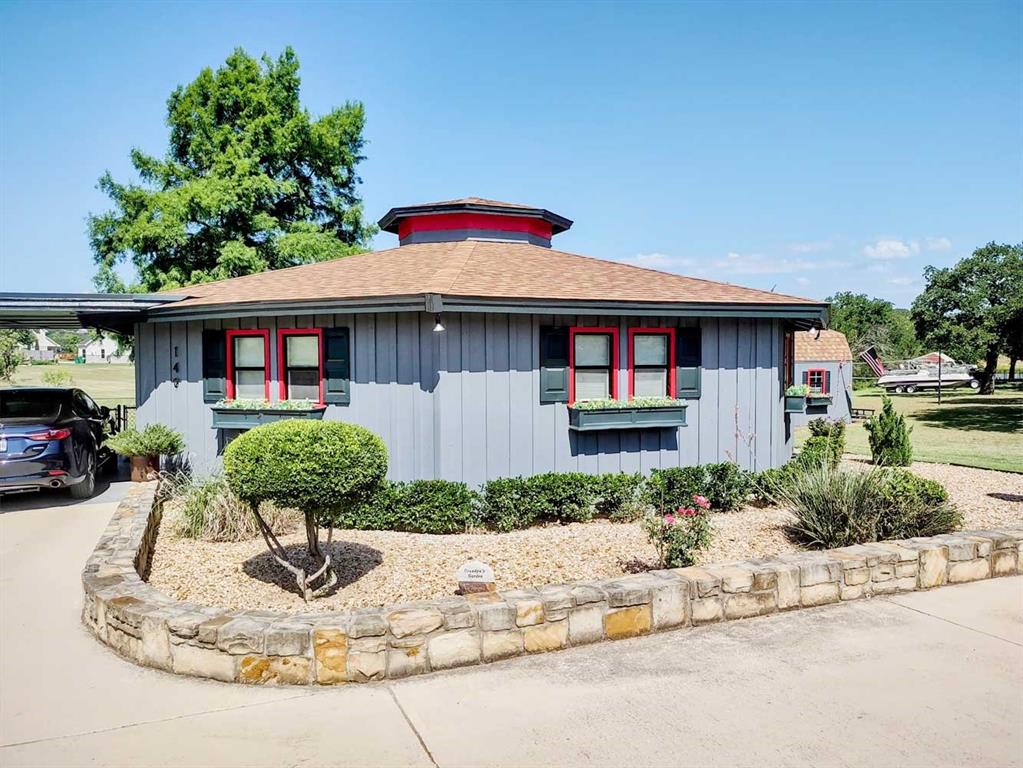 149 Bay Roc Lane Runaway Bay, TX 76426 - Photo 3 of 35 a front view of a house with garden