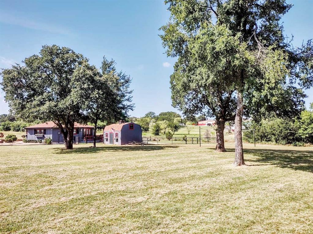 149 Bay Roc Lane Runaway Bay, TX 76426 - Photo 31 of 35 a view of a swimming pool with an outdoor space and seating area