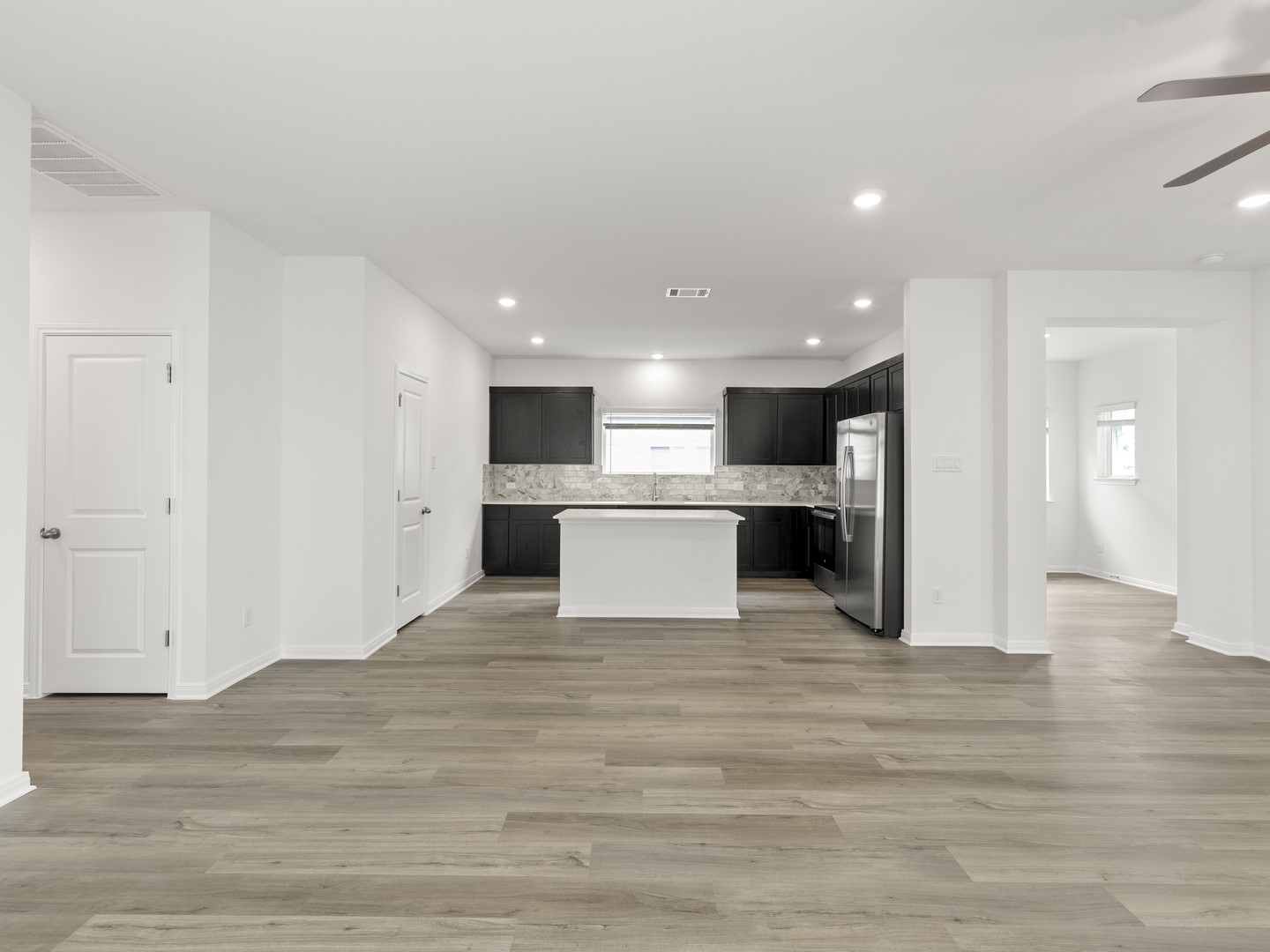 513 Yellow Ribbon Trail Jarrell, TX 76537 - Photo 21 of 23 An open floorplan seamlessly connects the well-appointed kitchen with stainless steel appliances and generous counter space.