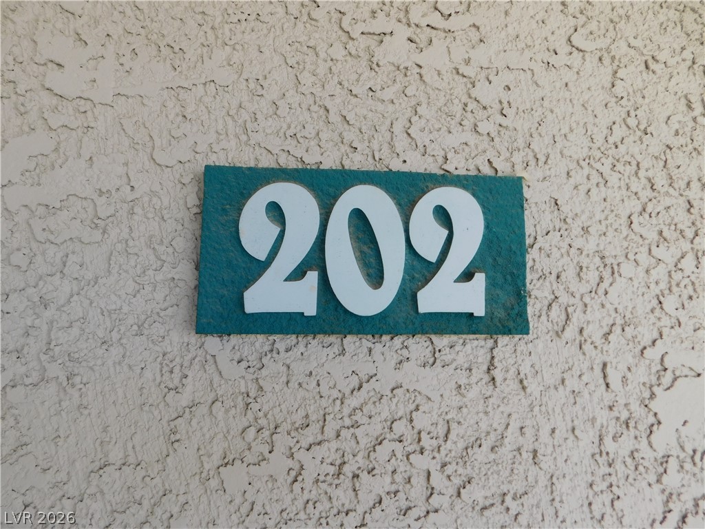 5221 South Lindell Road, Unit 202 Las Vegas, NV 89118 - Photo 4 of 28 Clearly visible address numbers on a textured exterior wall.