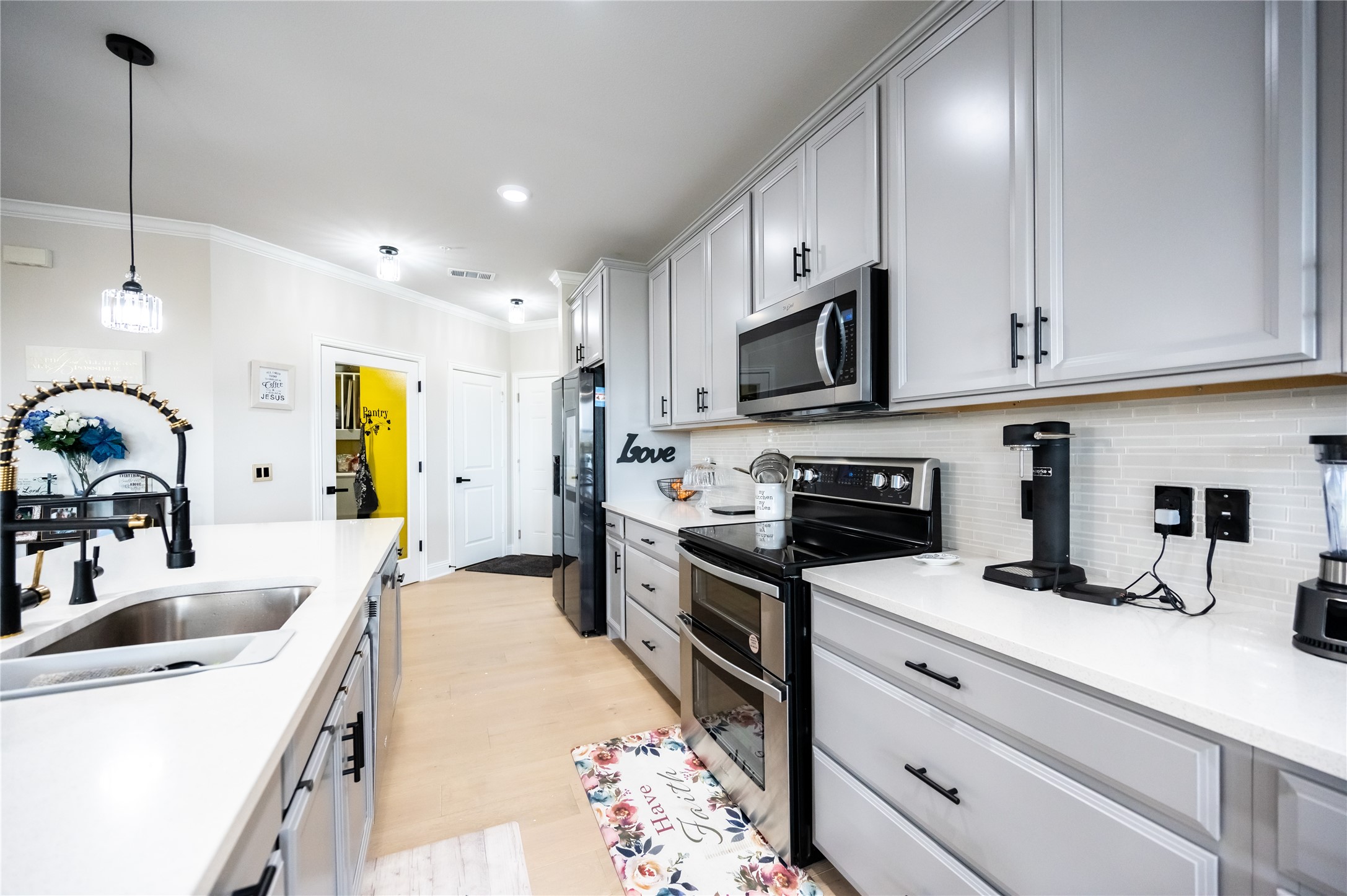 651 Watters Road, Unit 8201 Allen, TX 75013 - Photo 11 of 28 a kitchen with kitchen island granite countertop a sink stainless steel appliances and cabinets