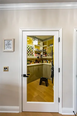 a living room with stainless steel appliances furniture a rug and a window
