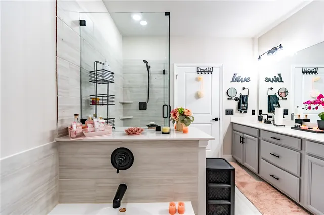 a bathroom with a sink mirror vanity and toilet