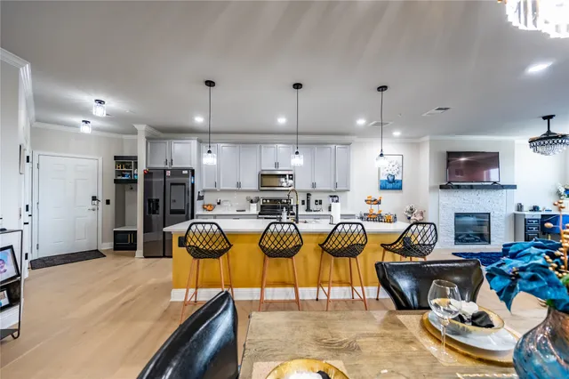 a living room with furniture and a dining table with kitchen view