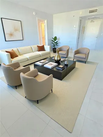 a living room with furniture and a potted plant