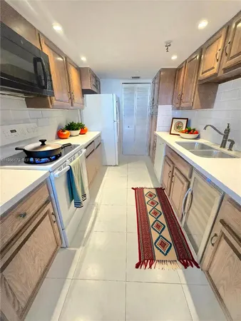 a kitchen with stainless steel appliances granite countertop a sink and a stove