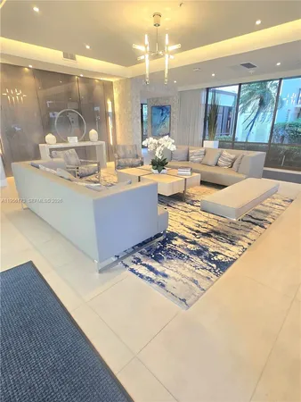 a living room with couches and dining table with kitchen view