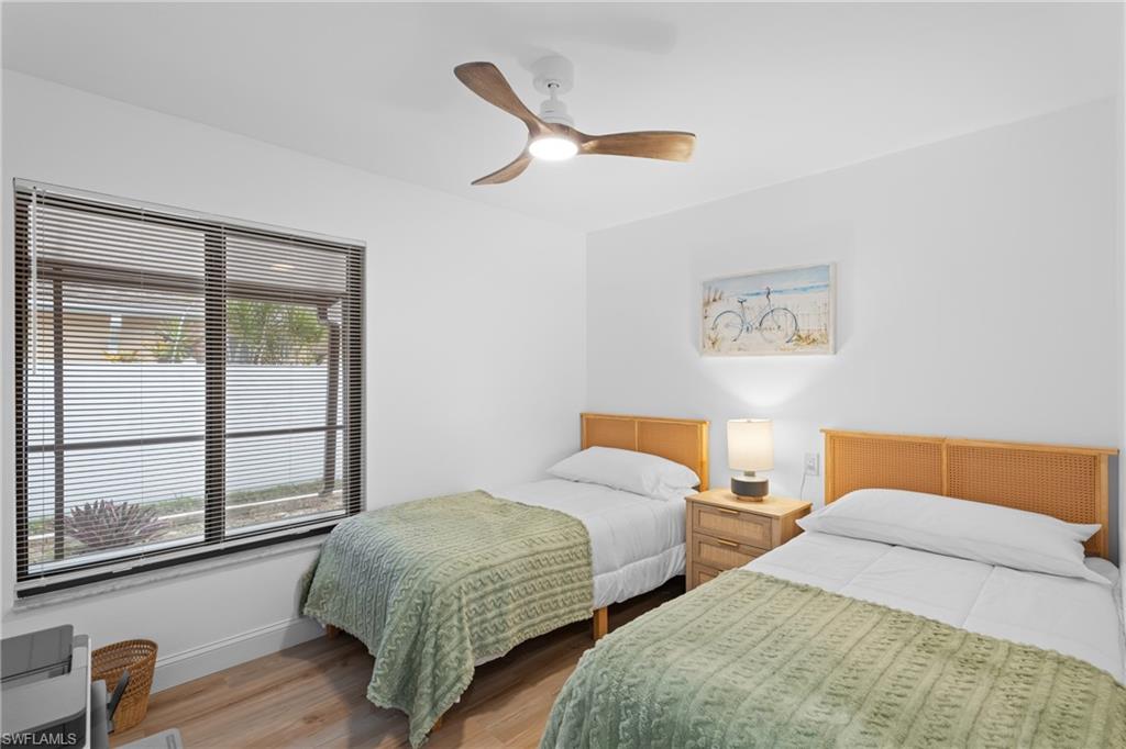 731 102nd Avenue North Naples, FL 34108 - Photo 14 of 23 a bedroom with two beds and a window
