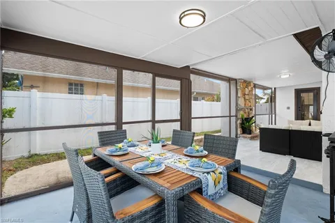 a view of a dining room with furniture large windows and wooden floor