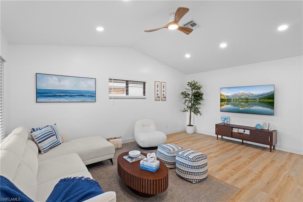 731 102nd Avenue North Naples, FL 34108 - Photo 3 of 23 a living room with furniture and a flat screen tv