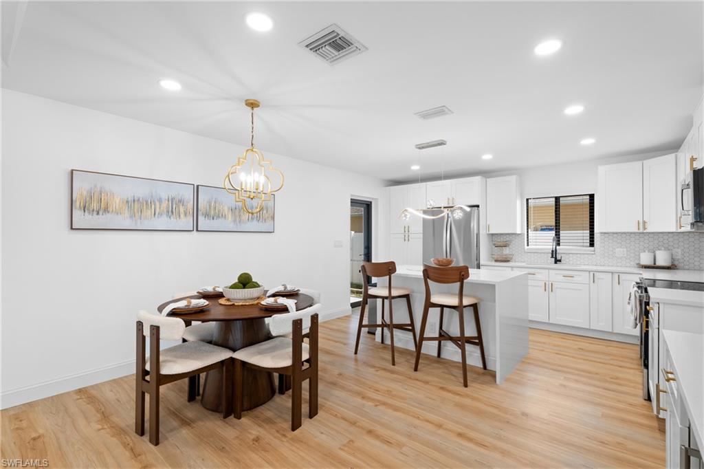 731 102nd Avenue North Naples, FL 34108 - Photo 5 of 23 a view of a dining room with furniture and wooden floor