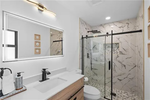 a bathroom with a sink toilet and shower