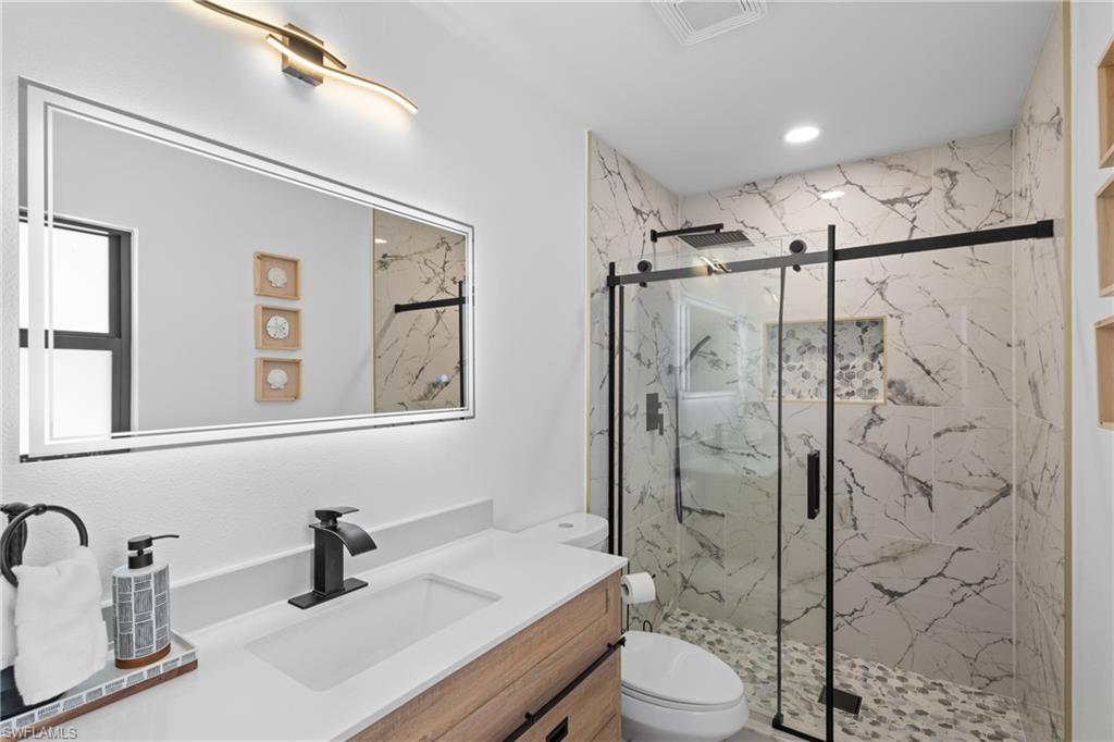 731 102nd Avenue North Naples, FL 34108 - Photo 10 of 23 a bathroom with a sink toilet and shower