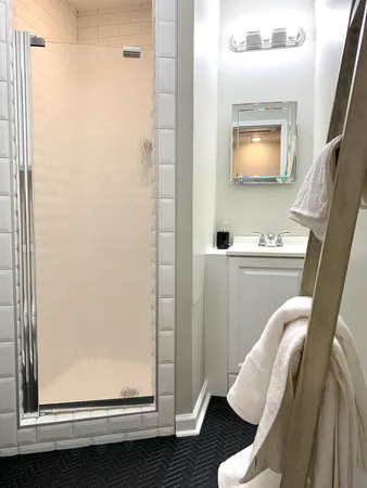 a bathroom with a window sink and mirror