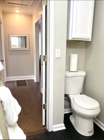 a white toilet sitting next to a bathroom sink