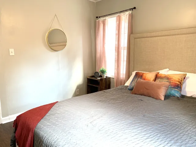 a bedroom with a bed and a window