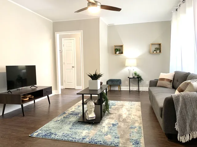 a living room with furniture and a flat screen tv