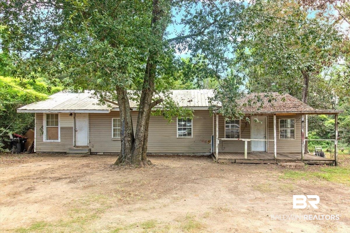 5386 Lott Road Eight Mile, AL 36613 - Photo 1 of 35 View of front of home featuring a metal roof and a wooden deck