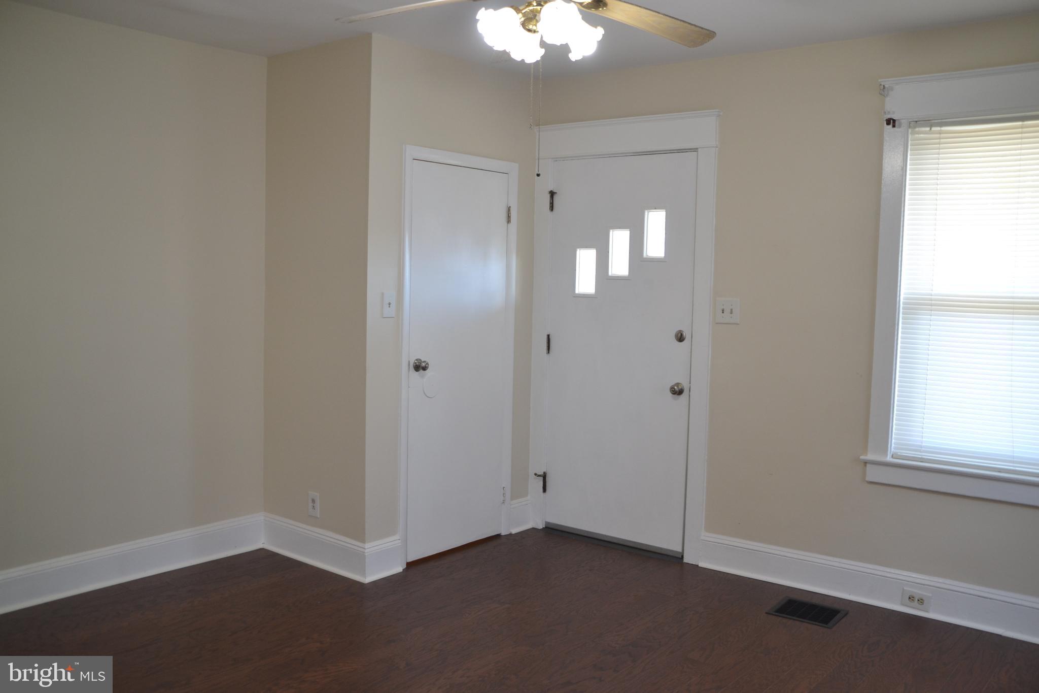 162 Burmont Road Drexel Hill, PA 19026 - Photo 11 of 42 a view of an empty room with window and wooden floor