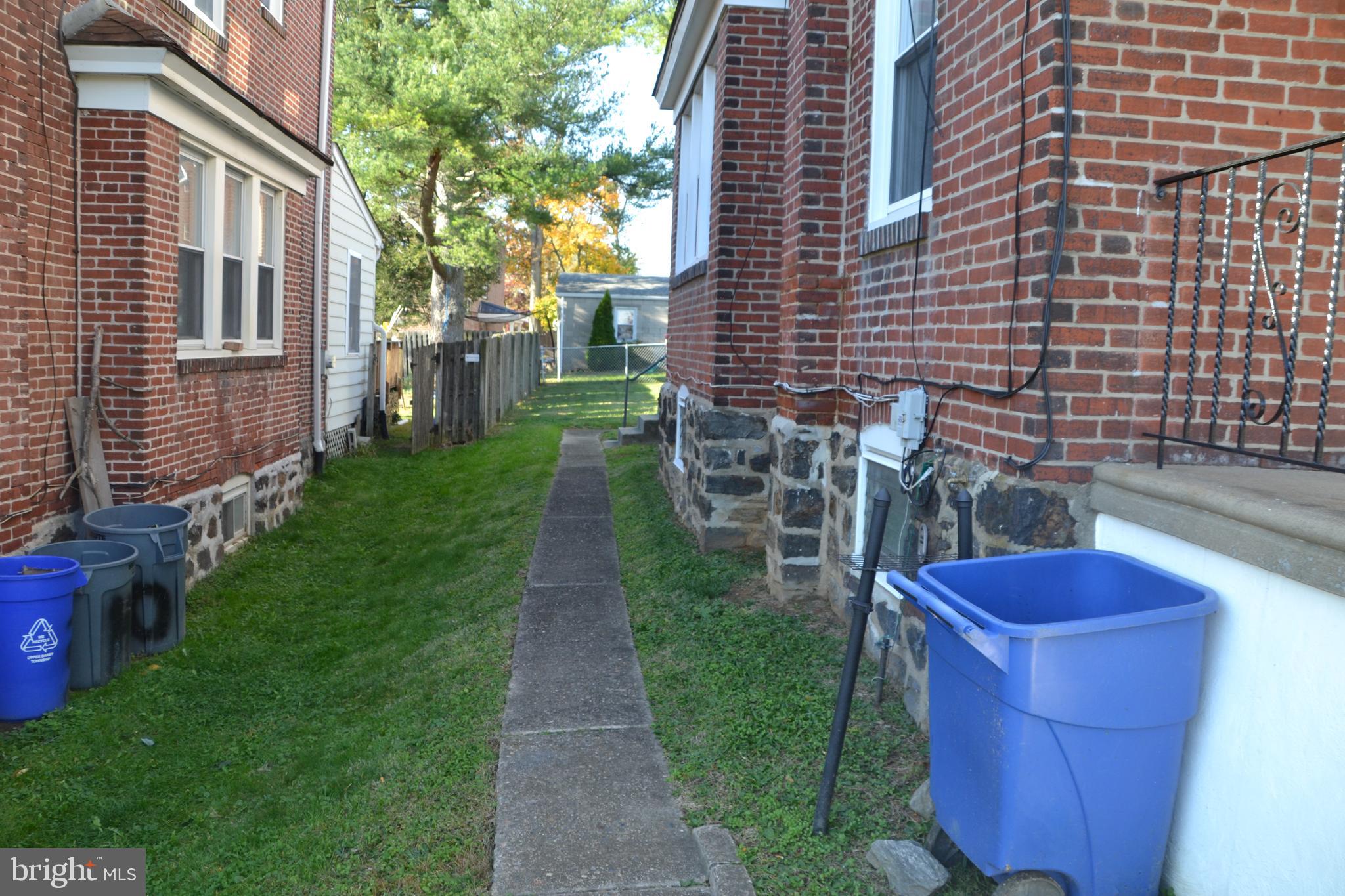 162 Burmont Road Drexel Hill, PA 19026 - Photo 3 of 42 a view of a backyard with table and chairs potted plants and a house