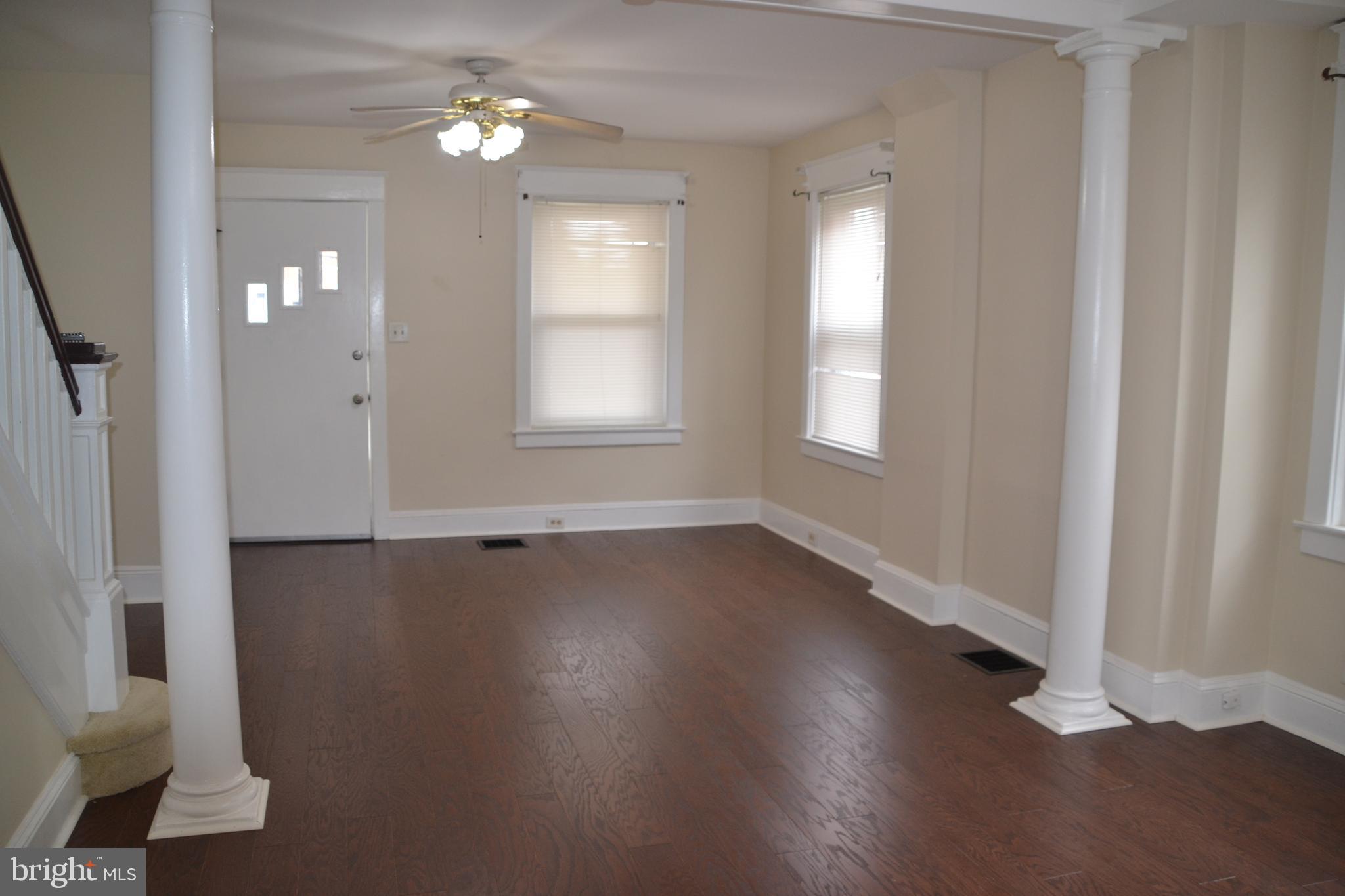 162 Burmont Road Drexel Hill, PA 19026 - Photo 8 of 42 an empty room with wooden floor and windows