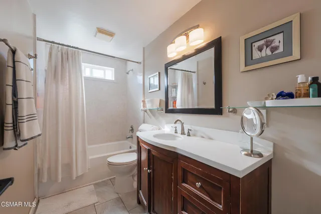 a bathroom with bathtub and shower
