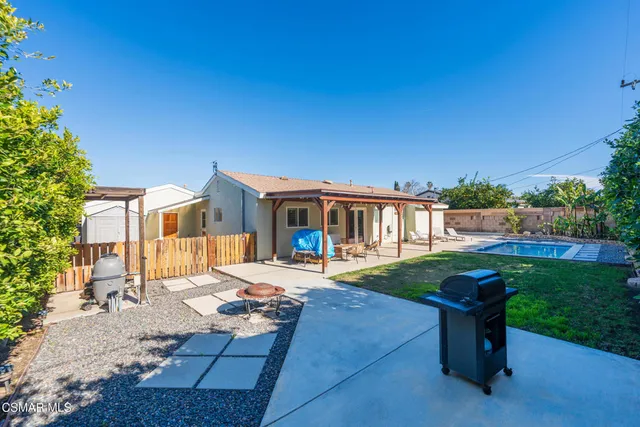 a view of a backyard with sitting area