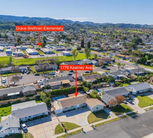 an aerial view of a house with pool patio and outdoor seating