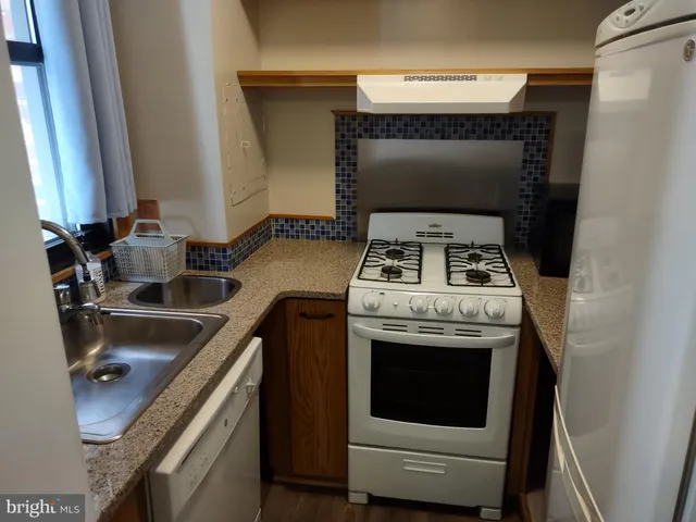 a kitchen with a stove and a sink