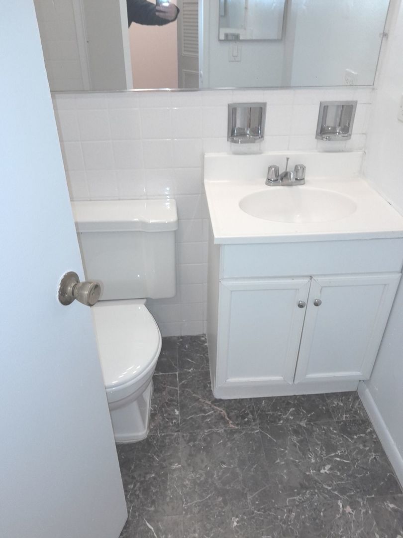 540 West Roscoe Street, Unit 382 Chicago, IL 60657 - Photo 11 of 13 a bathroom with a sink a toilet and vanity