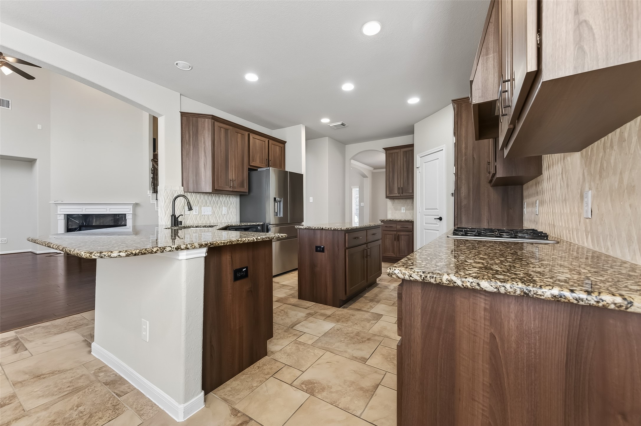22 North Arrow Canyon Circle Spring, TX 77389 - Photo 12 of 50 a kitchen with stainless steel appliances granite countertop a sink stove and refrigerator