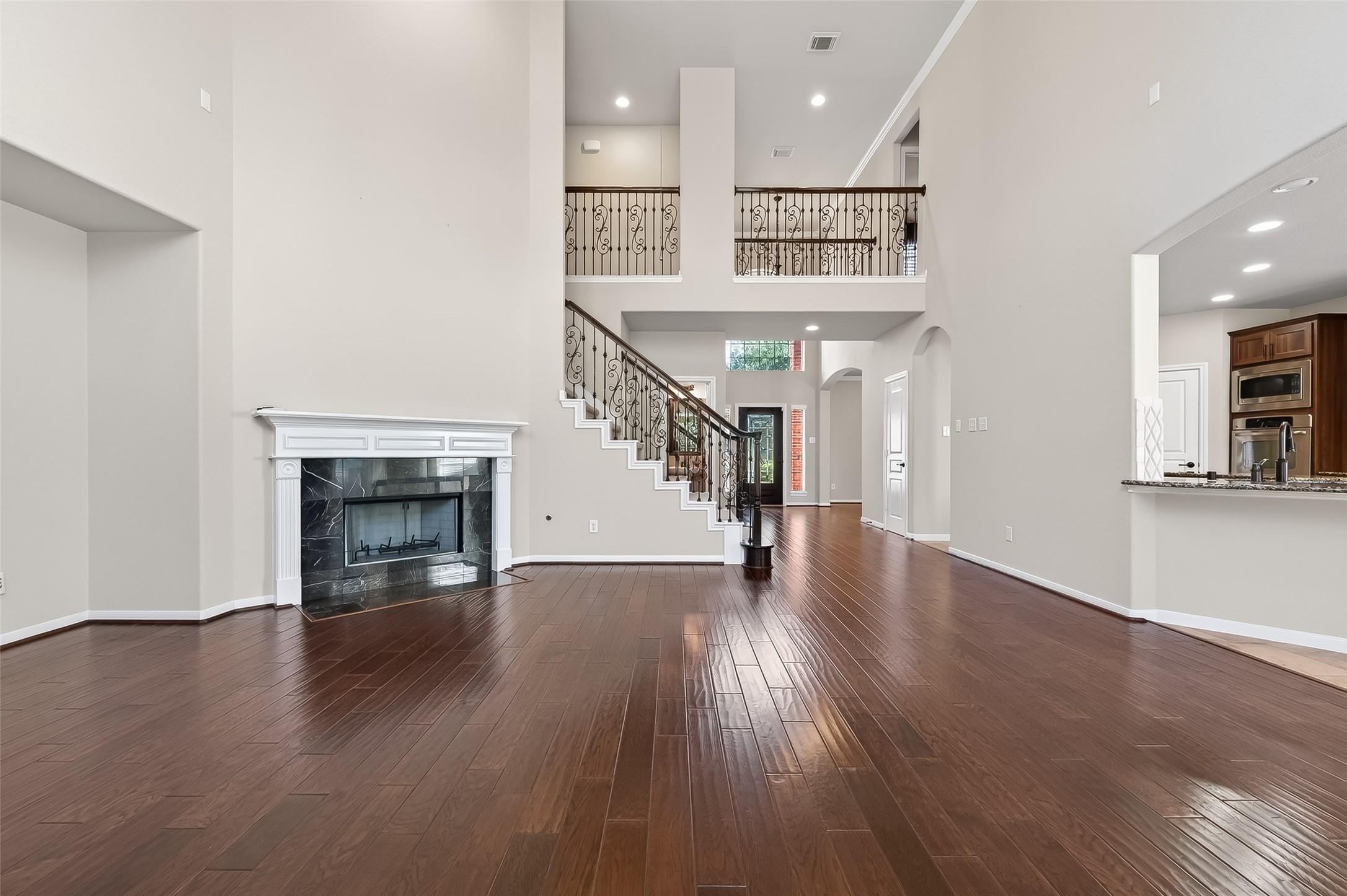 22 North Arrow Canyon Circle Spring, TX 77389 - Photo 16 of 50 a hallway with wooden floor fireplace and windows