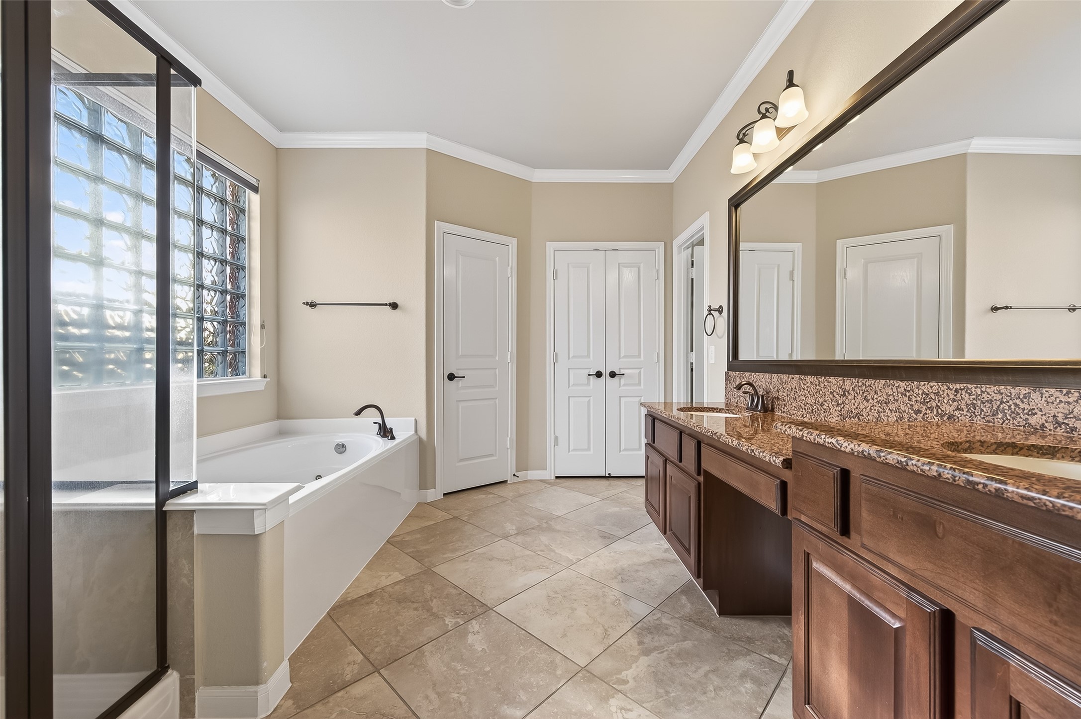 22 North Arrow Canyon Circle Spring, TX 77389 - Photo 39 of 50 a spacious bathroom with a granite countertop tub sink and mirror